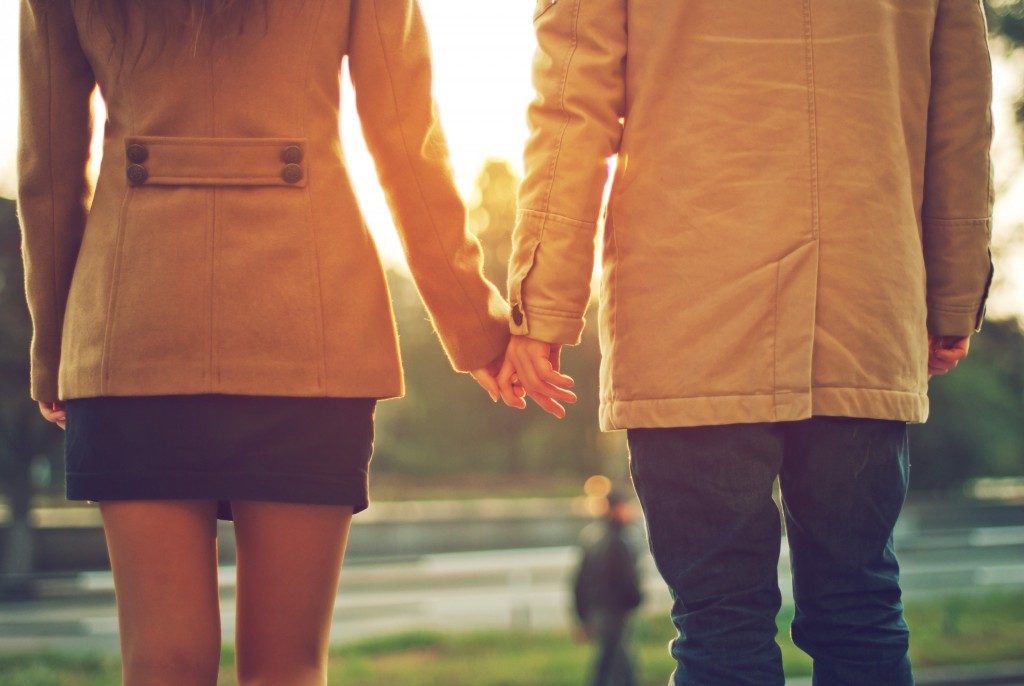 Couple in jacket holding hands