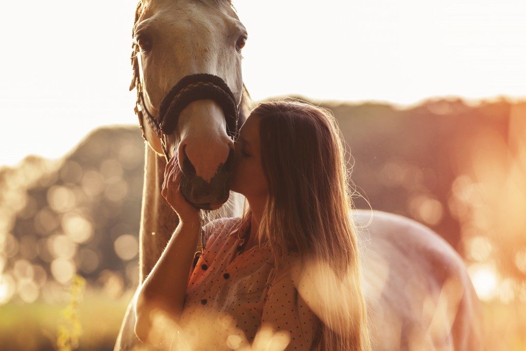 Woman kissing her horse
