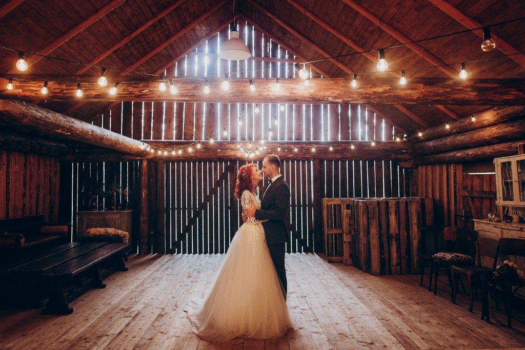 groom and wife dancing inside barnhouse