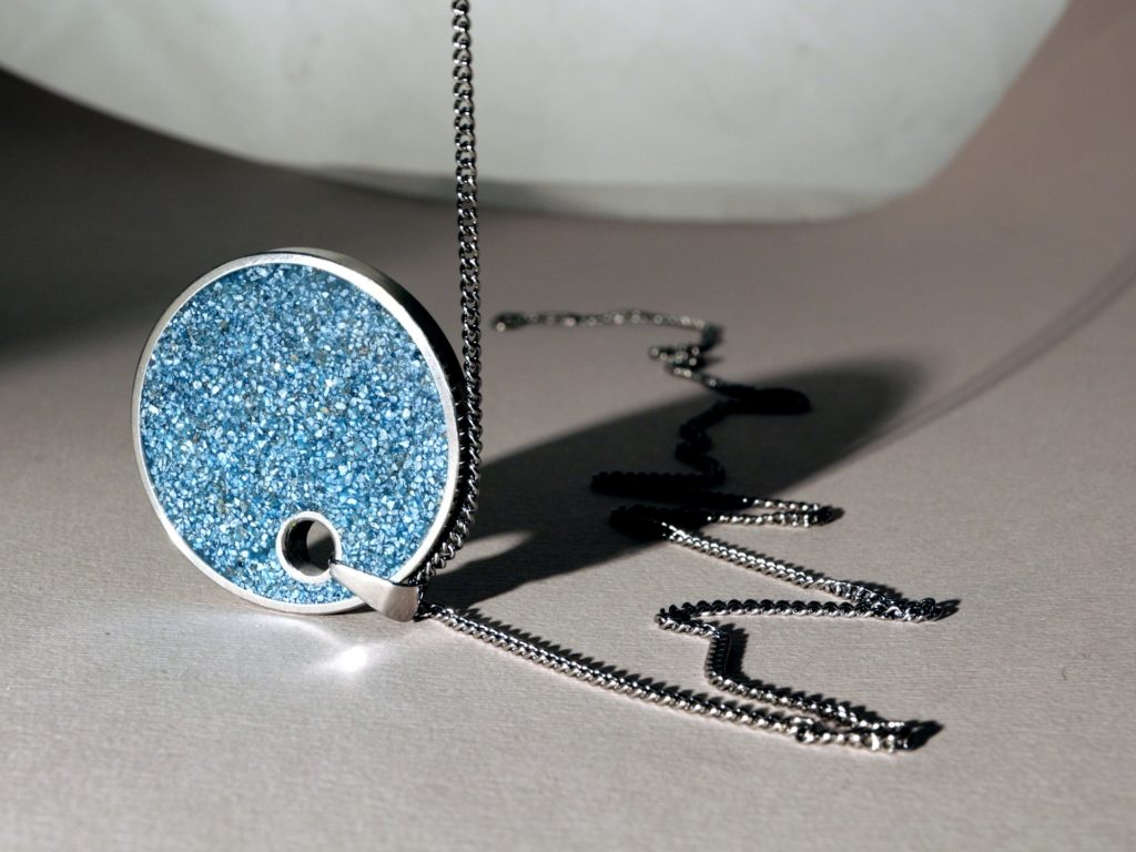 blue pendant with silver necklace