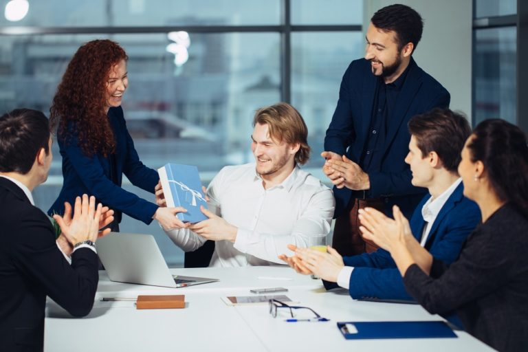 team giving gift to manager