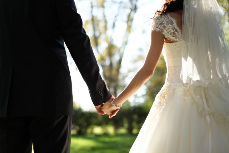 bride and groom holding hands