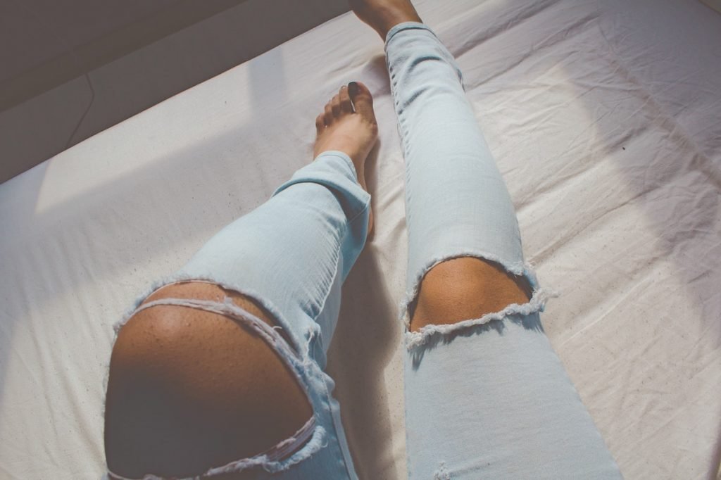woman wearing ripped jeans