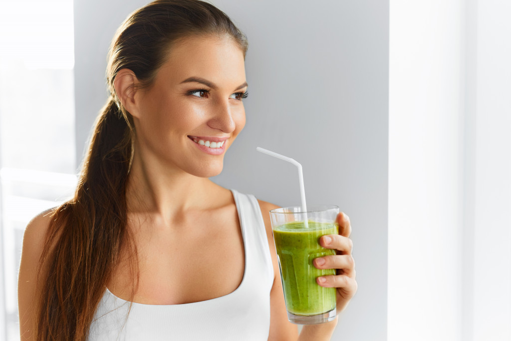 Diet. Healthy Eating Woman Drinking Fresh Raw Green Detox Vegetable Juice. Healthy Lifestyle, Vegetarian Food And Meal. Drink Smoothie. Nutrition Concept.