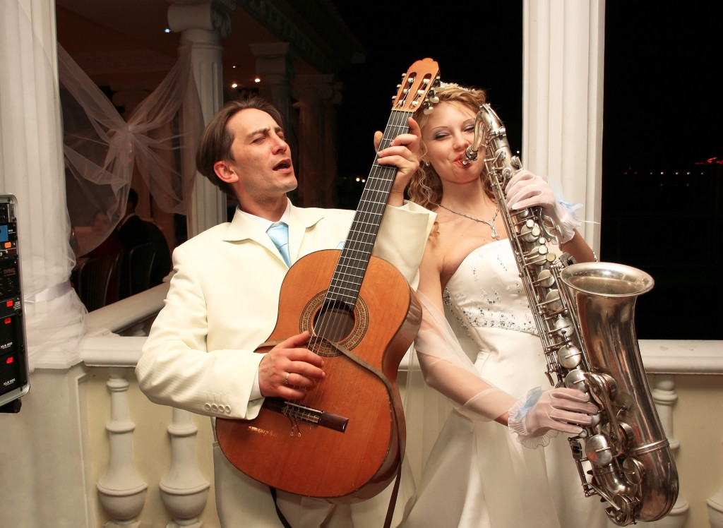 bride and groom playing music on wedding day
