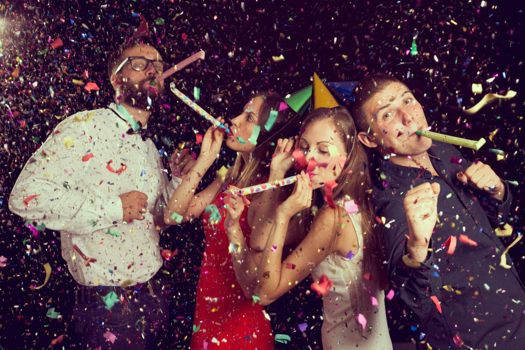 Two beautiful young couples having fun at New Year's party
