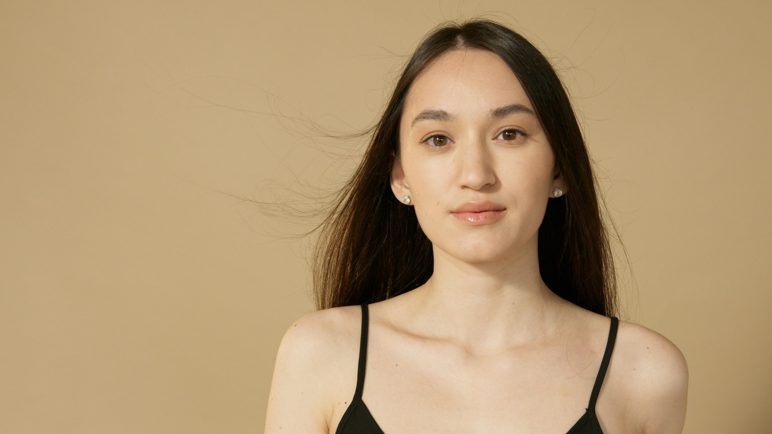 woman in a black tank top wearing natural makeup