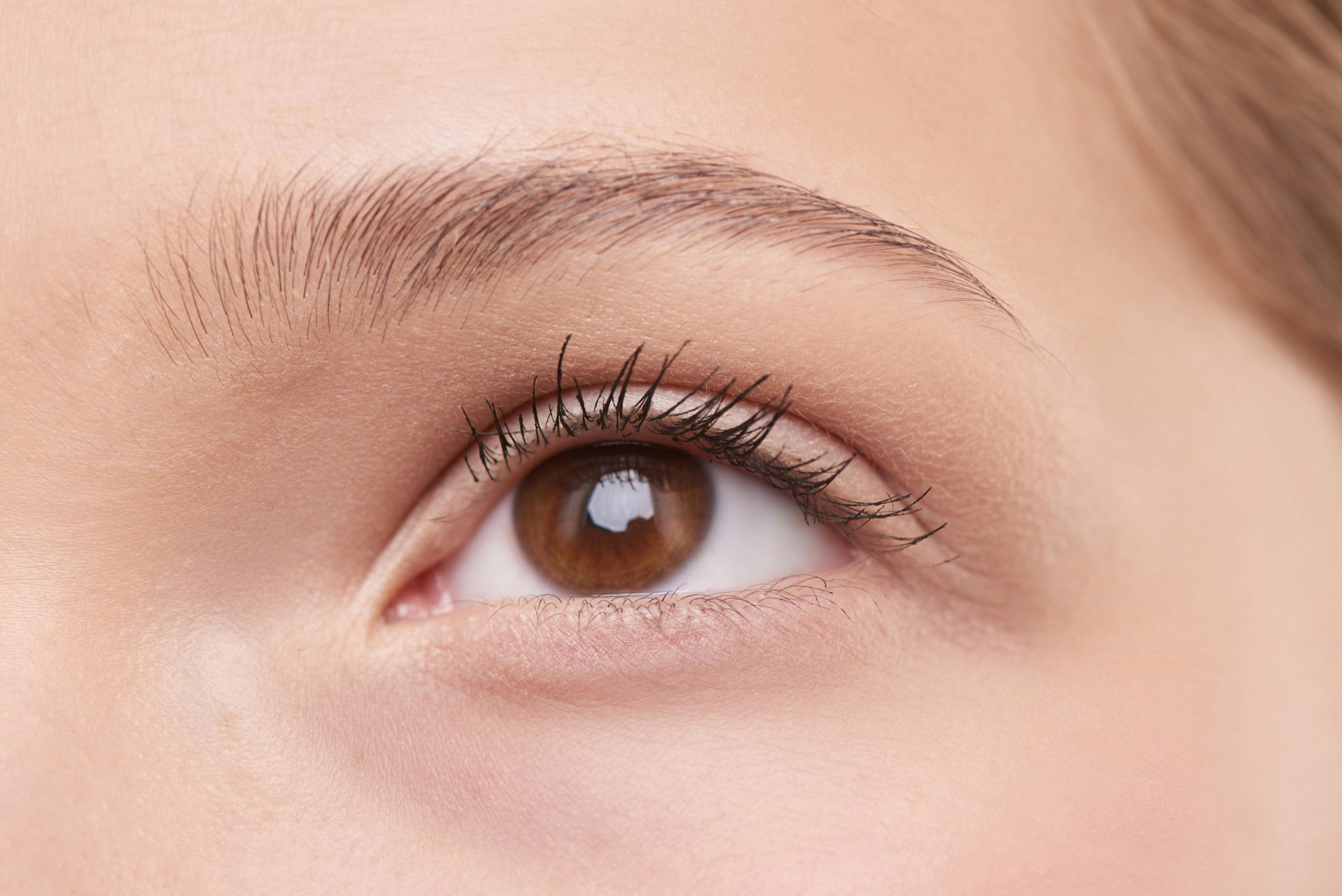 close-up of a person's eye with mascara on their eyelashes